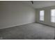 Spacious bedroom with grey carpet and ceiling fan at 415 Calamus Ct, Indianapolis, IN 46239