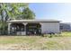 Outdoor barn with an open side and metal roof is filled with tools and equipment at 4462 S Morgantown Rd, Greenwood, IN 46143