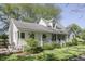 Quaint two-story home boasting a charming covered porch and well-manicured landscaping at 4462 S Morgantown Rd, Greenwood, IN 46143