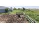 Overhead view of a fenced dirt paddock and green pasture with horses grazing on a sunny day at 4462 S Morgantown Rd, Greenwood, IN 46143