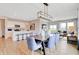 Open concept dining room with kitchen and living room views, hardwood floors, and large windows at 4553 Laughter Ln, Indianapolis, IN 46235