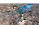 An aerial view shows a charming home nestled amongst trees near a lake at 459 W Lakeview Dr, Nineveh, IN 46164