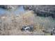 Aerial view of a modern waterfront home nestled among trees with lake access at 459 W Lakeview Dr, Nineveh, IN 46164