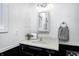 Small bathroom with a dark vanity, a framed mirror, and a white countertop at 459 W Lakeview Dr, Nineveh, IN 46164