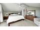 Serene bedroom with a king-size bed, a ceiling fan, and a large dresser at 459 W Lakeview Dr, Nineveh, IN 46164