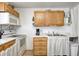Kitchen with wood cabinets, white appliances, and a double sink at 459 W Lakeview Dr, Nineveh, IN 46164