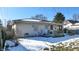 Rear view of the house showcasing a deck and partially snow-covered yard at 5806 E 19Th St, Indianapolis, IN 46218