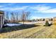 View of backyard, partially covered in snow, and a pond at 6336 Burgin Dr, Whitestown, IN 46075