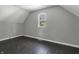 Simple bedroom with dark wood floors and a window at 7077 E Mulberry St, Gwynneville, IN 46144