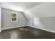 Bright bedroom with dark hardwood floors and a window with a view of trees at 7077 E Mulberry St, Gwynneville, IN 46144