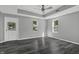 Bedroom with gray walls, dark floors, and a white door at 7077 E Mulberry St, Gwynneville, IN 46144