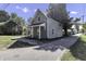 Gray house with a wraparound porch and a tree-lined street at 7077 E Mulberry St, Gwynneville, IN 46144