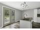 Kitchen with island, double sink, and French doors to backyard at 7077 E Mulberry St, Gwynneville, IN 46144