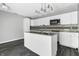 Modern kitchen with white cabinets, stainless steel appliances, and an island at 7077 E Mulberry St, Gwynneville, IN 46144
