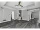 Spacious living room with gray walls and dark gray wood-look floors at 7077 E Mulberry St, Gwynneville, IN 46144