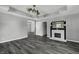 Living room featuring a fireplace and ceiling fan at 7077 E Mulberry St, Gwynneville, IN 46144