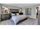 Main bedroom with tufted headboard, striped bedding, and dark wood furniture at 7474 Fallsworth Dr, Avon, IN 46123