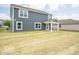 Exterior view of the home with a spacious backyard and covered patio at 7541 Big Bend Blvd, Camby, IN 46113