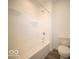 Cozy bathroom featuring a shower-tub combo and toilet at 7541 Big Bend Blvd, Camby, IN 46113