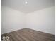 Bright, empty bedroom showcasing hardwood floors, neutral walls, and ample natural light at 7541 Big Bend Blvd, Camby, IN 46113