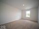 Sunny bedroom with neutral carpet and a window offering a glimpse of the outdoors at 7541 Big Bend Blvd, Camby, IN 46113