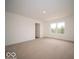 Bright bedroom with a large window, neutral carpet, and a glimpse of the home's exterior at 7541 Big Bend Blvd, Camby, IN 46113
