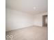 A cozy bedroom showcasing neutral carpet, white walls, and a doorway leading to another room at 7541 Big Bend Blvd, Camby, IN 46113