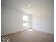 Bright bedroom with neutral carpet, a window overlooking a garden, and ample natural light at 7541 Big Bend Blvd, Camby, IN 46113