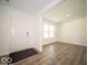 Bright entryway featuring hardwood floors, a white front door, and ample natural light at 7541 Big Bend Blvd, Camby, IN 46113