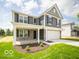 Attractive home with a covered porch, gray siding, white trim, and a well-maintained lawn at 7541 Big Bend Blvd, Camby, IN 46113