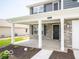 Welcoming covered front porch with stone accents, white pillars, and a stylish black front door at 7541 Big Bend Blvd, Camby, IN 46113