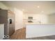 Stylish kitchen features stainless steel appliances, a center island, and white cabinetry at 7541 Big Bend Blvd, Camby, IN 46113