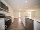 Modern kitchen with stainless steel appliances, stone countertops, and ample cabinet space at 7541 Big Bend Blvd, Camby, IN 46113