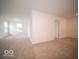Expansive living room featuring neutral carpet, bright windows, and an open doorway at 7541 Big Bend Blvd, Camby, IN 46113