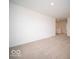 Open living room with neutral carpet and a glimpse into the home's layout and design at 7541 Big Bend Blvd, Camby, IN 46113