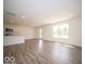 Open concept living area with hardwood floors, white walls, recessed lighting, and a view of the kitchen at 7541 Big Bend Blvd, Camby, IN 46113