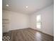 Open-concept living space with hardwood floors and access to the outdoors at 7541 Big Bend Blvd, Camby, IN 46113