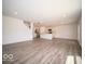 Expansive open-concept living area with kitchen, hardwood floors, white walls, and abundant natural light at 7541 Big Bend Blvd, Camby, IN 46113