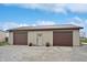 Detached two-car garage with brown doors and metal roof at 7675 E 500 N, Lebanon, IN 46052