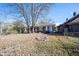Backyard with autumn leaves, showing a brick building and fire pit at 836 S Tremont St, Indianapolis, IN 46221