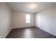 Simple bedroom with gray laminate flooring and a single window at 836 S Tremont St, Indianapolis, IN 46221