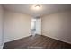 Cozy bedroom with gray laminate floors and an open door to another room at 836 S Tremont St, Indianapolis, IN 46221