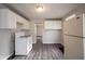 Kitchen features white appliances and vinyl flooring at 836 S Tremont St, Indianapolis, IN 46221