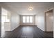 Spacious living room featuring three windows and dark gray laminate floors at 836 S Tremont St, Indianapolis, IN 46221