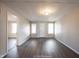 Simple living room with hardwood floors and neutral walls at 836 S Tremont St, Indianapolis, IN 46221