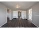 Bright living room with dark gray laminate flooring and built-in shelving at 836 S Tremont St, Indianapolis, IN 46221