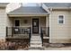 Inviting front porch with black railing and small patio set at 85 E Poplar St, Zionsville, IN 46077