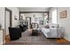 Spacious living room with light gray sofa and dark armchairs at 85 E Poplar St, Zionsville, IN 46077