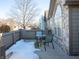 Small patio with table and chairs, partially covered by snow at 879 Gazebo Way, Greenwood, IN 46142