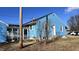 Side view of a blue house with a screened porch and yard at 901 W Marsh St, Muncie, IN 47303